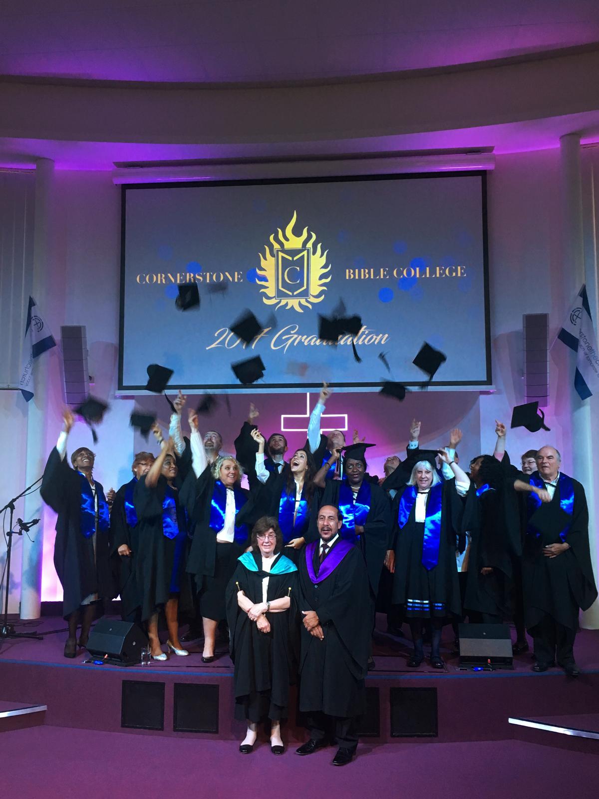 Cornerstone Bible College graduation, students throwing caps in the air