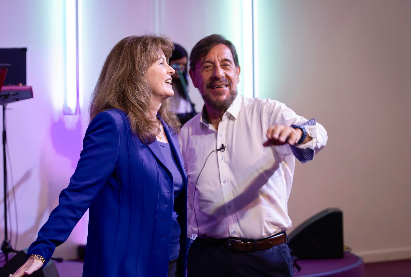Pastors Chris and Loraine sharing a candid moment on stage