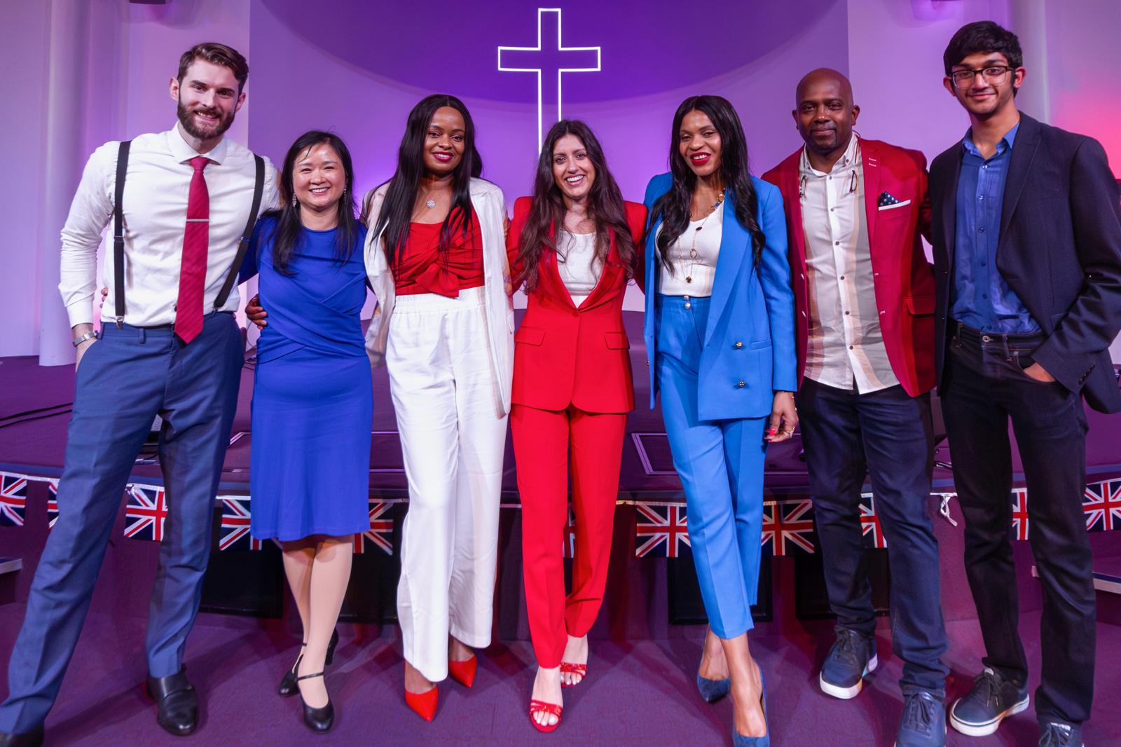 Cornerstone members on stage in coordinated red, white and blue outfits with Union Jack bunting