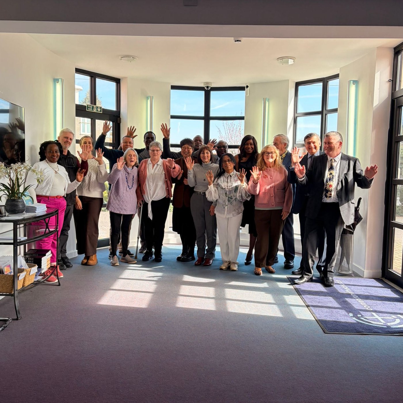 Cornerstone ushering team waving in the foyer