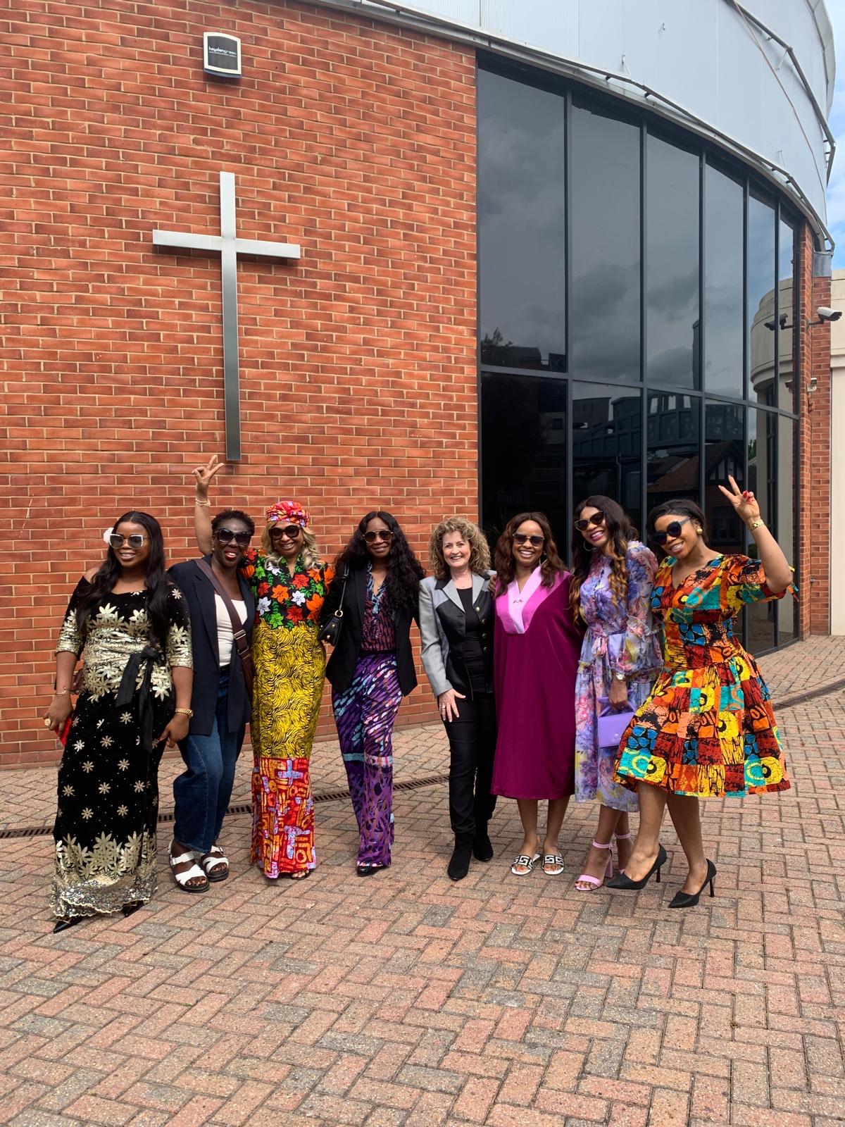 Women from many nations outside the church in colourful traditional dress